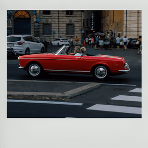 A red convertible on a street