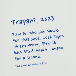 The back, handwritten: Trapani, 2023. Flew it into the clouds for this shot. Lost sight of the drone, flew it back blind. Heart jumped for a second. Shot on DJI Mini 3 Pro.